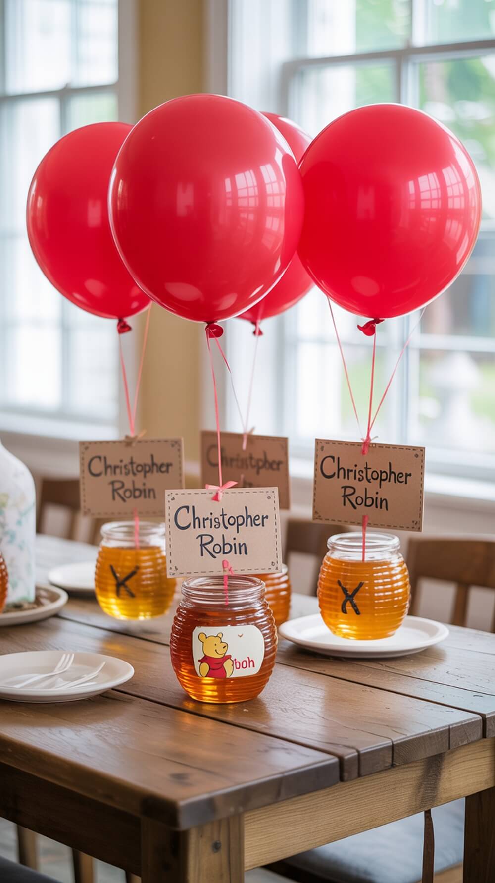 A table setting with red balloons and honey jars for a Winnie the Pooh baby shower.