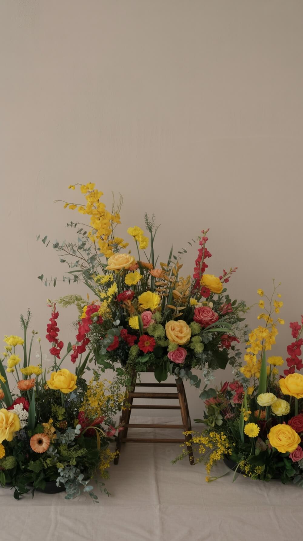Colorful floral arrangements inspired by Winnie the Pooh theme, featuring yellow and pink flowers in playful containers.