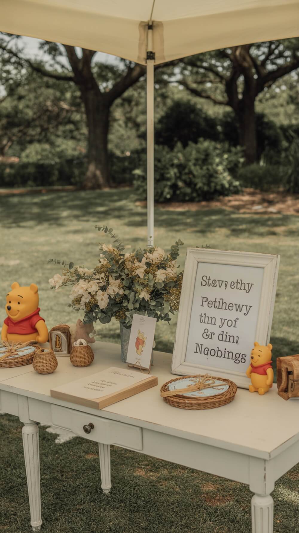 A beautifully decorated welcome table for a Winnie the Pooh baby shower with figurines, flowers, and a welcoming sign.